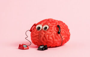 human-brain-model-with-two-retro-phones-on-pink-ba-2025-03-08-04-23-37-utc